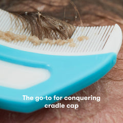 Frida Baby FlakeFixer brush massaging to loosen cradle cap flakes safely