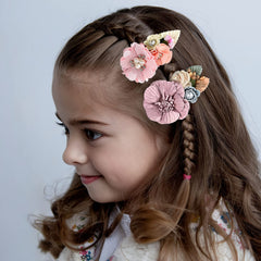 Fsmiling hair bows with pink flowers on an alligator clip, ideal for daily wear.