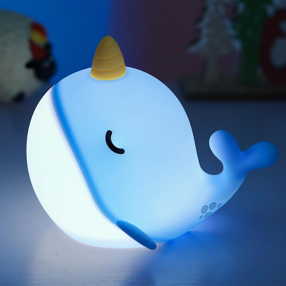 Fuloon Narwhal Night Light in blue tap-control mode for bedtime routines.