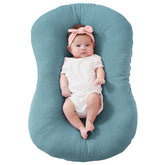 FUNUPUP Muslin baby lounger cover in blue flatlay, showing soft breathable fabric for baby comfort.