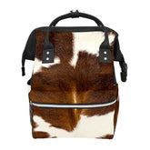 GACTIVITY brown cowhide diaper bag front view showing organized pockets for on-the-go use.