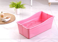 Ganen Baby Bath Tub Portable Pink folded for compact storage and travel.