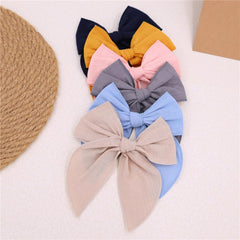 Gebelle velvet pink bow clip closeup highlighting durable fabric and stylish party-ready look.