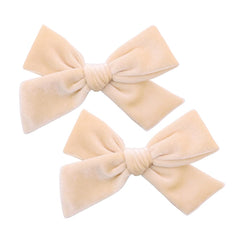Gebelle cream velvet bow with alligator clip — secure for everyday wear.