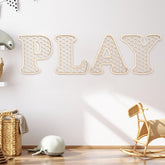 Generic Play Sign wooden letters on wall with warm rustic finish for a cozy playroom.