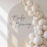 GIOGUK Baby is Brewing wall decal as a playful baby shower backdrop.