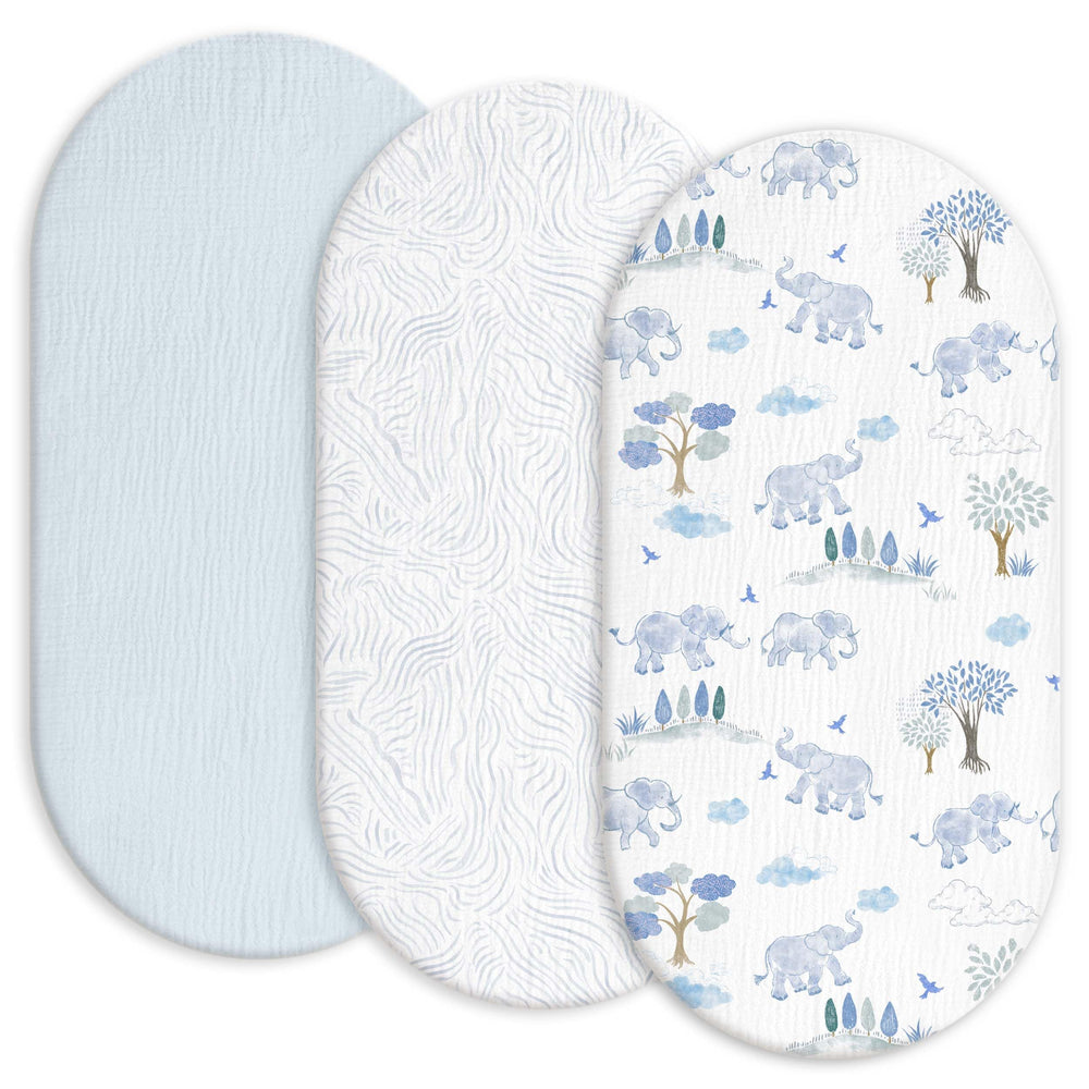 Gllquen Baby muslin bassinet sheets in light blue on bed for breathable comfort.