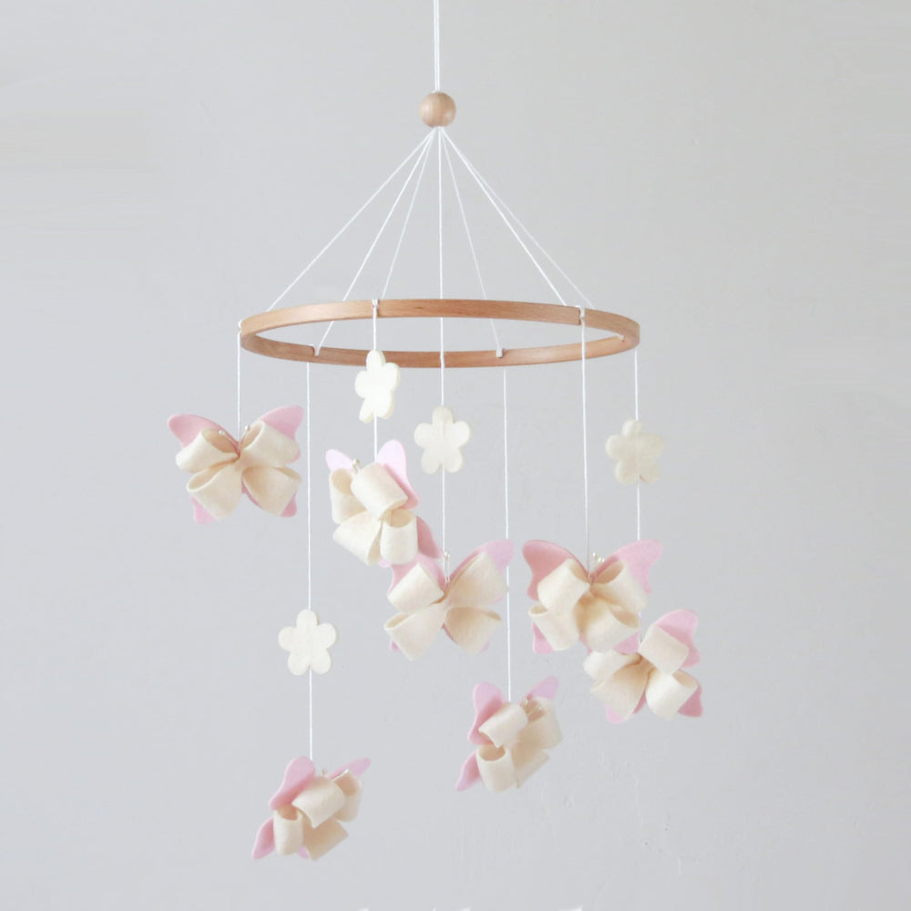 GOUKURLSMA butterfly mobile for crib with seven butterflies and four flowers in a calm nursery scene