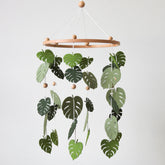 Goukurlsma green leaf mobile forest crib setup promotes visual tracking for babies.
