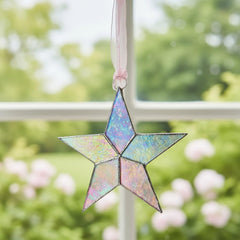 The Grandparent Gift Co pink organza ribbon star ready to hang in a nursery.