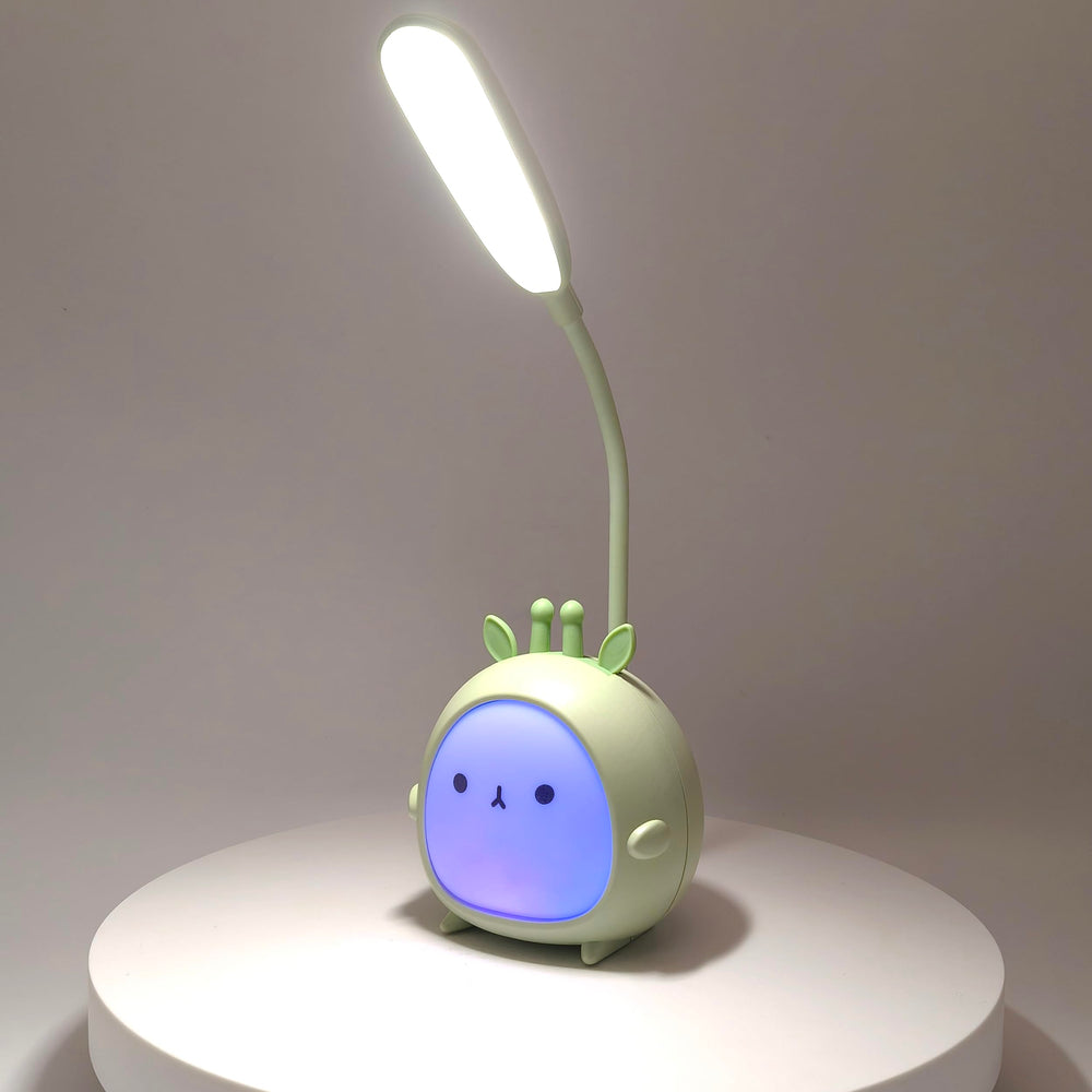 Green Deer LED night light on table delivering soft nursery glow.
