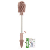 haakaa cleaning brush double-ended pink in action for versatile bottle and pump cleaning.