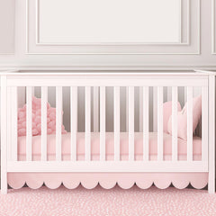 Hahafelt pink scalloped crib skirt front view adds timeless nursery charm and easy coordinating decor.