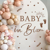 HATARU Baby in Bloom sign backdrop highlights festive baby shower decor.