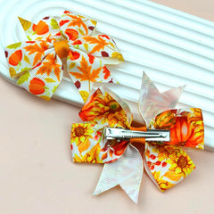 HOXIEYA pumpkin and maple leaf design clip grips hair without slipping.