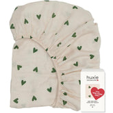 Huxie 24x38 mini crib sheet closeup shows soft texture for baby comfort.