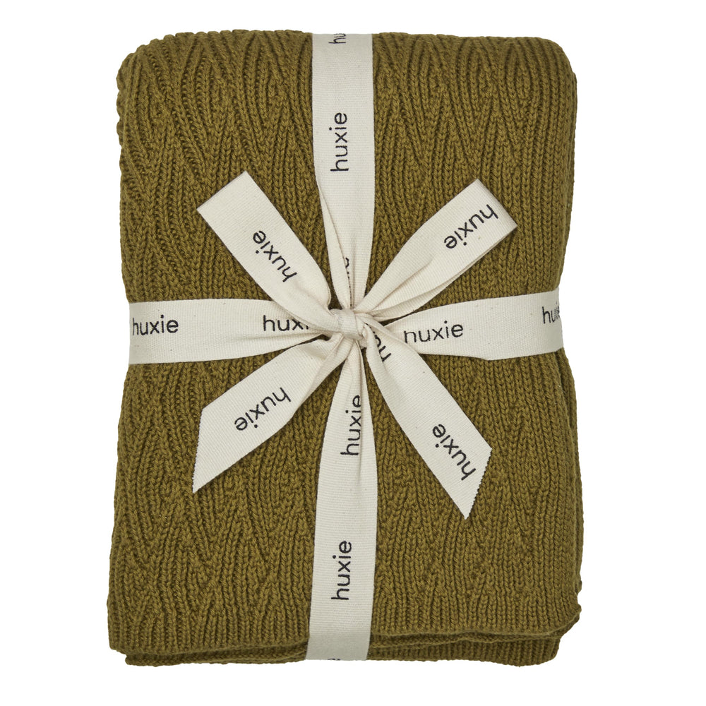 Huxie knitted baby blanket moss green close-up showing ultra-soft organic cotton texture for newborn comfort