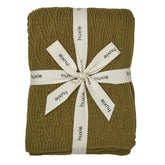 Huxie knitted baby blanket moss green close-up showing ultra-soft organic cotton texture for newborn comfort