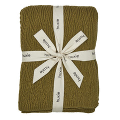Huxie knitted baby blanket moss green close-up showing ultra-soft organic cotton texture for newborn comfort