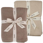 Huxie knitted baby blanket close-up shows soft textured knit for cozy newborn comfort.