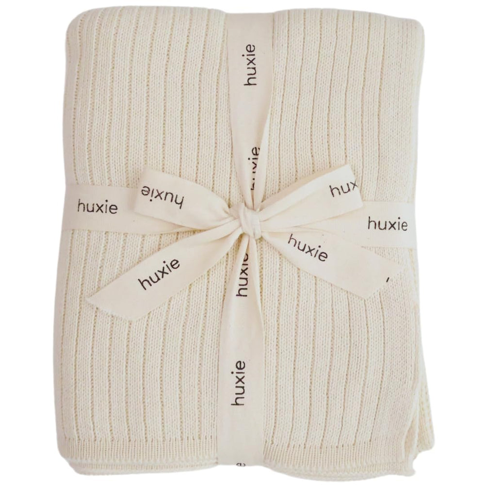 Huxie Knitted Baby Blanket soft white closeup shows plush organic cotton texture for sensitive skin