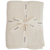 Huxie Knitted Baby Blanket soft white closeup shows plush organic cotton texture for sensitive skin