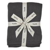 Huxie Knitted Baby Blanket closeup shows ultra-soft organic cotton texture for gentle newborn comfort.