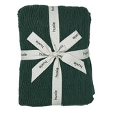 Huxie Knitted Baby Blanket texture close-up shows plush organic cotton softness