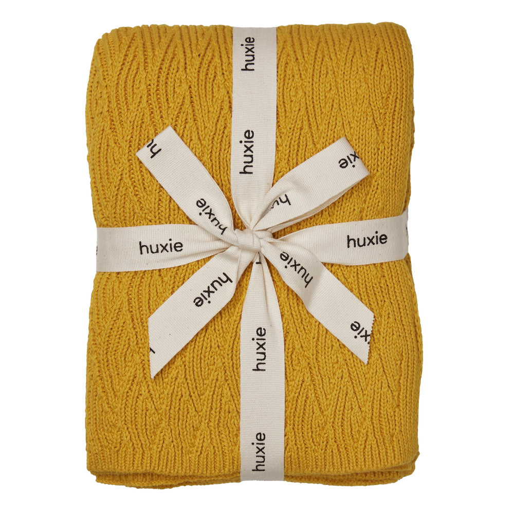 Huxie Waves Yellow knitted blanket closeup showing ultra-soft organic cotton for delicate skin