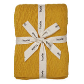 Huxie Waves Yellow knitted blanket closeup showing ultra-soft organic cotton for delicate skin
