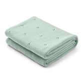 Huxie pointelle knitted blanket in Roman Green close-up showing soft texture for newborn snuggles.
