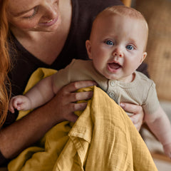 Huxie Swaddle Autumn Yellow close-up fabric shows pre-washed muslin fibers