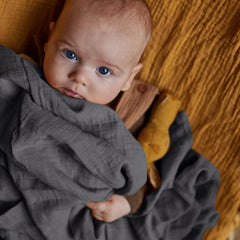 Huxie Swaddle nursing-cover usage shows practical daily feeding privacy with baby.