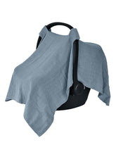Huxie Tradewinds organic muslin car seat cover draped over a stroller for privacy.