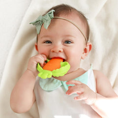 Infantino Lil’ Nibbles teether baby hands holding demonstrates easy-to-grip design.
