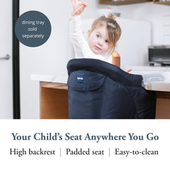 Inglesina Fast Table Chair Navy attached to a table for stable child seating.