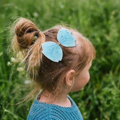 inSowni blue-teal bow clip brightens outfits for playful photos.