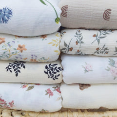 Insular muslin baby blanket blue dandelion shown as crib and stroller companion for everyday comfort.