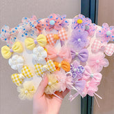 IPEWOEF mini hair bows flower clip close-up showing soft fabric and pearl accents for baby styling.