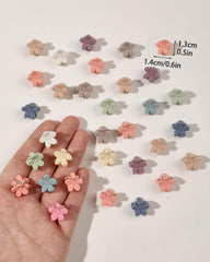 Ivyu tiny flower clip for toddler buns shows gentle, secure grip.