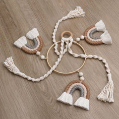JILPAK macrame rainbow mobile on wooden hoop offers tactile textures for baby observation.