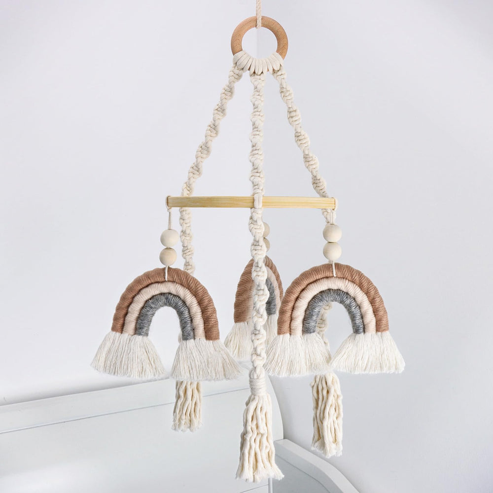 JILPAK neutral baby crib mobile with macrame rainbow shines softly over a crib, inspiring calm visual focus.