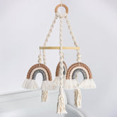 JILPAK neutral baby crib mobile with macrame rainbow shines softly over a crib, inspiring calm visual focus.