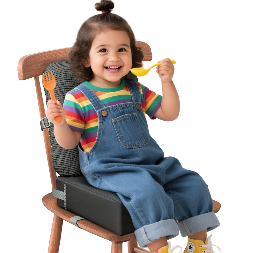 JLGCUF booster seat on dining chair, front view showcasing compact, portable design for meals.