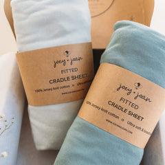 Joey + Joan cradle sheets close-up shows ultra-soft jersey cotton ideal for gentle nights.