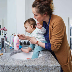 Johnson's Baby Lotion cap-off pump demonstrates easy one-hand application.