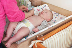 Jola's House baby girl changing pad cover enhances a cozy nursery look while staying in place.