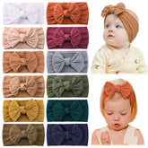 Jollybows 12pcs nylon baby headbands with bows in closeup emphasize vibrant color options for outfits.