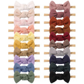 Jollybows 3.2-inch waffle bow on a stretchy nylon headband for newborn comfort