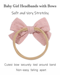 Jollybows baby bow on a smiling baby during a photo shoot.